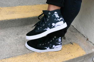 A closeup of high top sneakers with a Stormtrooper, Star Wars style design. 