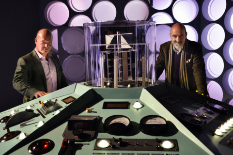 Big Finish's Co-Executive Producers Jason Haigh-Ellery and Nicholas Briggs stand at a Classic-Who era TARDIS console