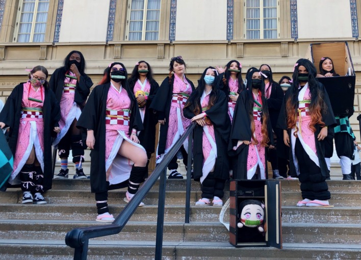 A group of Nezuko cosplayers gather on the steps in front of the Pasadena Convention Center