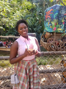 Fashion designer Arkeida Wilson holds a Dole Whip ice cream cone at Disneyland on Dapper Day. 