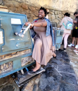 Arkeida Wilson rides a landspeeder at Galaxy's Edge, wearing her vintage design inspired by Finn from Star Wars. 