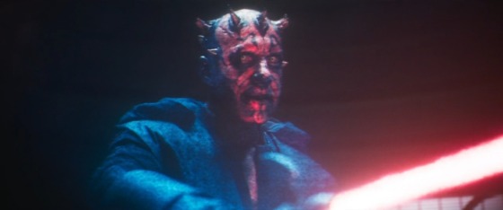 Maul appears as a hologram in Solo: A Star Wars Story. The hood of his robes is down and he holds an activated red bladed lightsaber in his hands