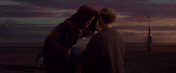 Obi-Wan, with his brown Jedi cloak's hood over his head, delivers the newborn Luke to his Aunt Beru on Tatooine