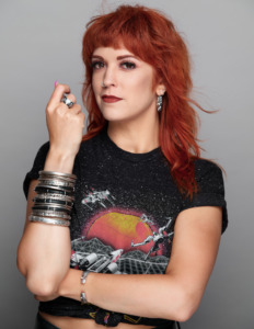 RockLove CEO Allison Cimino poses wearing a Star Wars shirt and an armful of silver bangles.