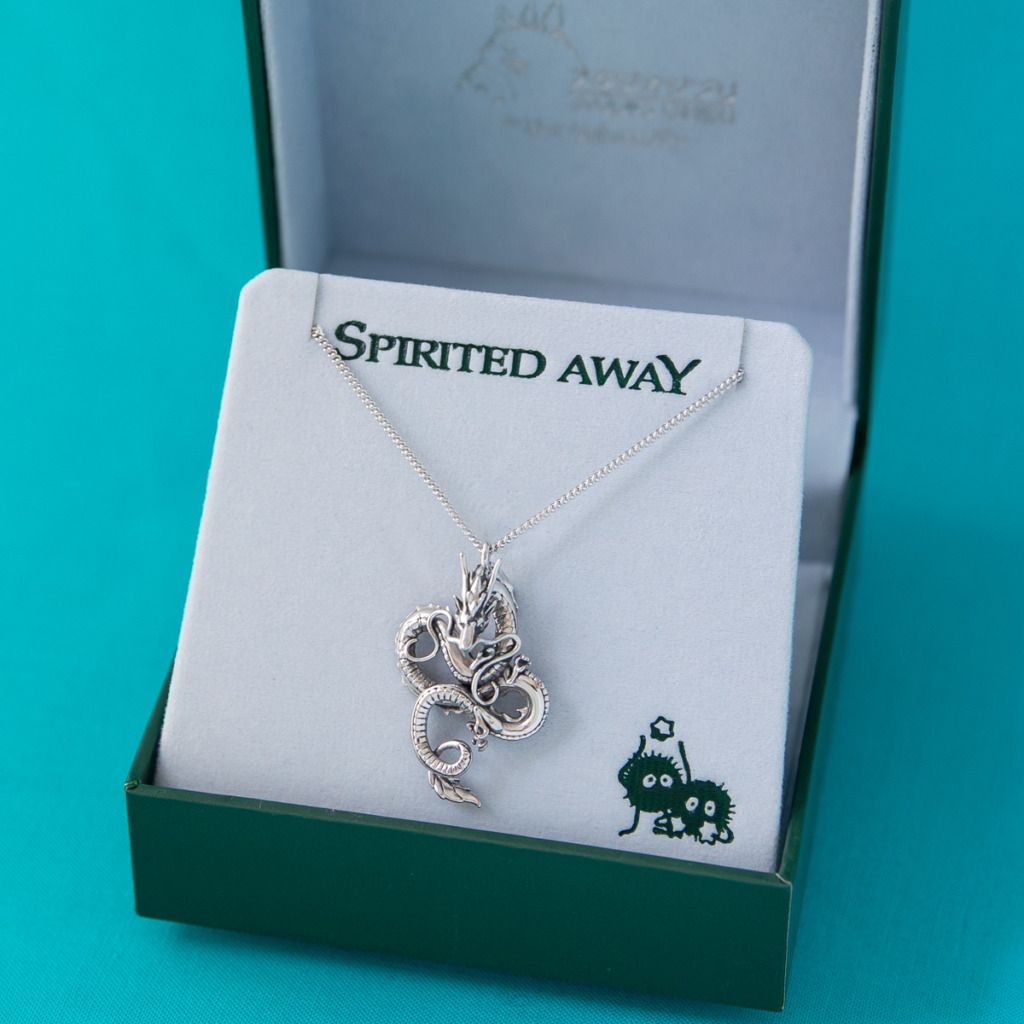 A sterling silver dragon Haku necklace in a jewelry box with the Spirited Away logo. 