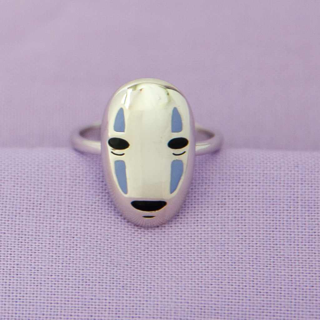 The No-Face Ring displayed against a purple background from RockLove and Her Universe's Spirited Away jewelry line. 