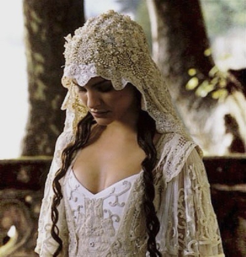 Padme Amidala looks down demurely wearing a lacy white veil and wedding dress in a scene from Star Wars: Attack of the Clones. 