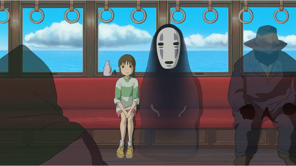 An animated still with Chihiro and No-Face on a train from Spirited Away. 