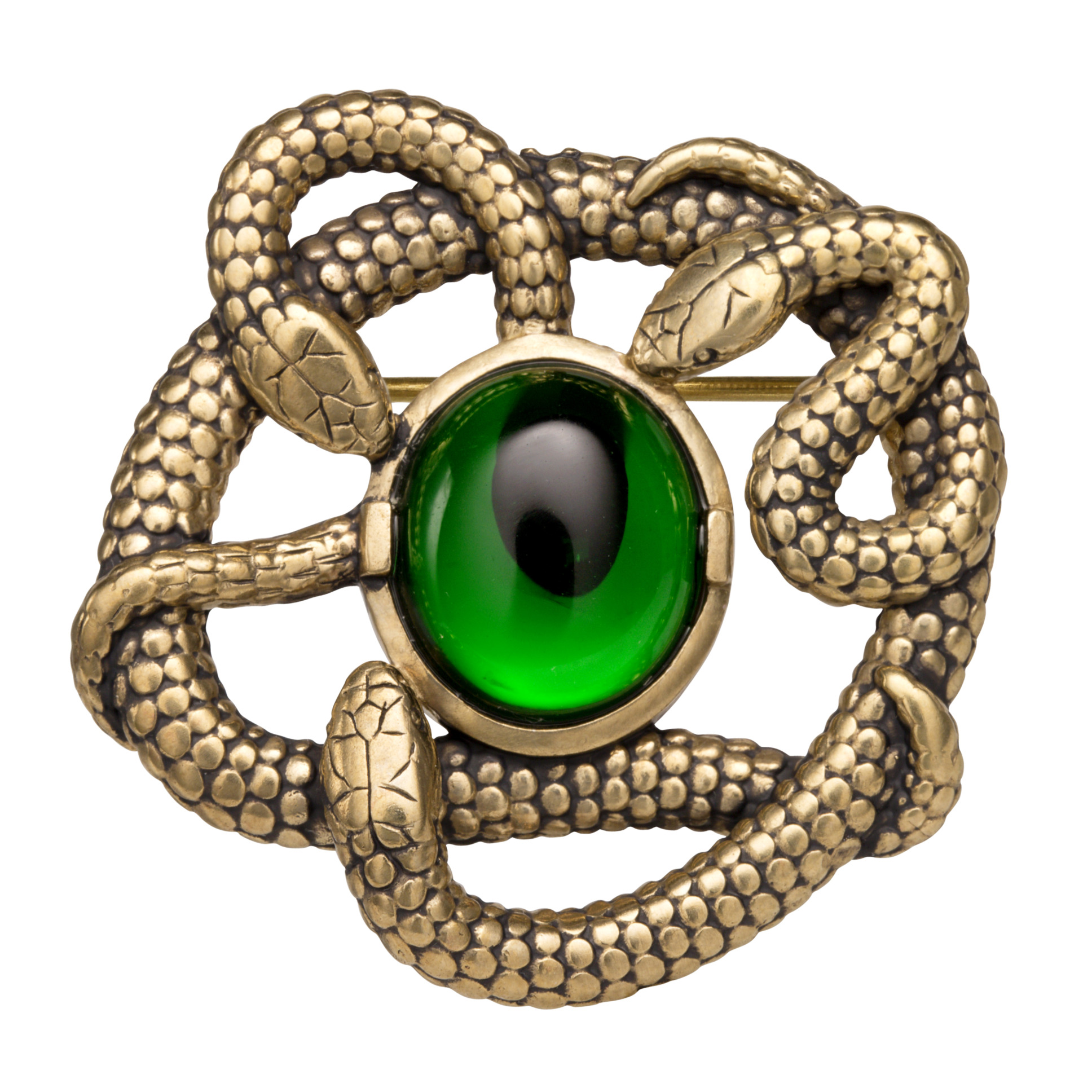 A brooch in antiqued brass features three snakes entwined around a green crystal.