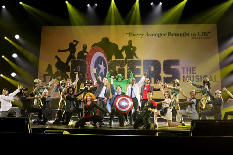 On stage were 22 performers, a six-piece live rhythm section, and composer and conductor Marc Shaiman, who wrote the song for Hawkeye. ANAHEIM, CALIFORNIA - SEPTEMBER 10: Rogers The Musical performs onstage during D23 Expo 2022 at Anaheim Convention Center in Anaheim, California on September 10, 2022. (Photo by Jesse Grant/Getty Images for Disney)