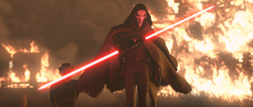 a dark figure with a double-bladed lightsaber walks towards the camera with fire burning behind him