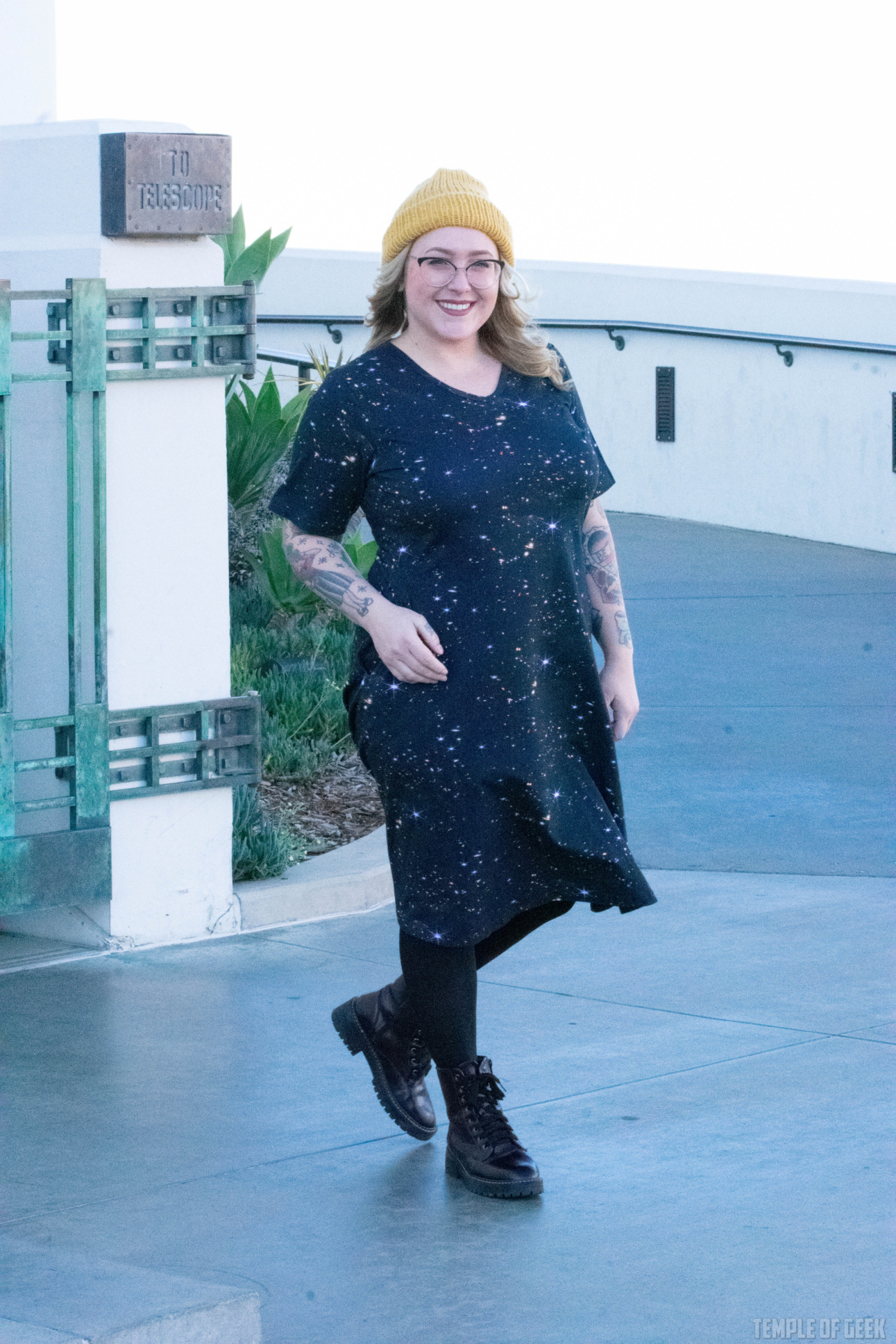 A model walks outside Griffith Observatory in a black dress with an image from the James Webb telescope on it.