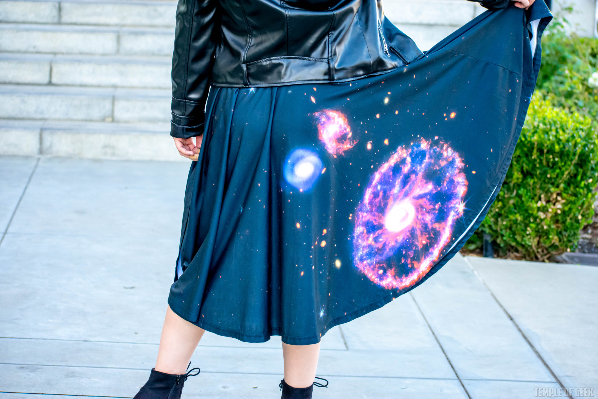 Closeup of a model showing off the space-themed skirt she wears.