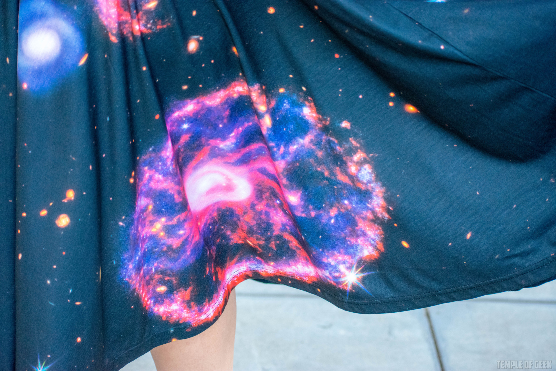 Closeup of the Cartwheel Galaxy in the Sculptor's Acrobat Constellation on a black skirt in motion.