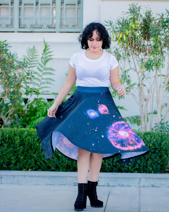 A model twirls in a full skirt to show a galaxy design on it from Svaha's space-themed apparel.