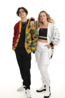 A female model, wearing a Shinobu inspired cardigan, has her arm over the shoulder of a male model wearing a Giyu inspired cardigan