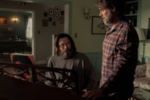 From left to right: Bill (Nick Offerman) sits at a piano and looks up at Frank (Murray Bartlett) in HBO The Last of Us Episode Three.