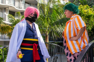 Two cosplayers wearing sk8 the infinity cosplay posing in front of palm trees