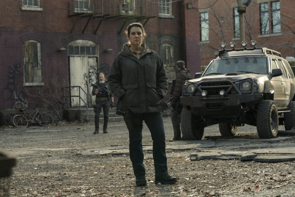 Melanie Lynskey as Kathleen from The Last of Us episode four stands in a barren part of Kansas City