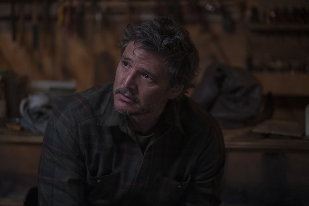 Joel (Pedro Pascal) looks to side, crying