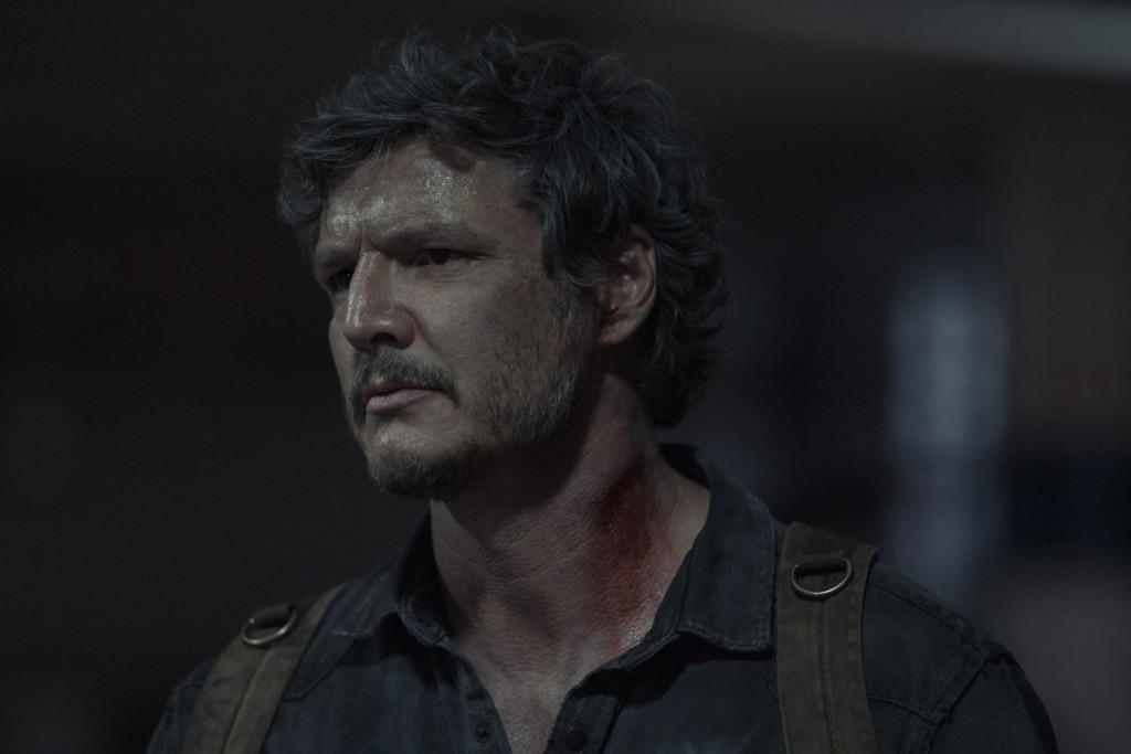 Joel (Pedro Pascal) looks to the side, there is blood on his neck.