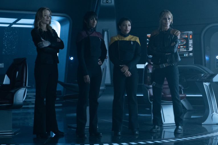 Michelle Hurd as Raffi Musiker, Ashlei Sharpe Chestnut as Ensign Sidney La Forge, Mica Burton as Alandra La Forge and Jeri Ryan as Seven of Nine standing alongside each other on the bridge of the U.S.S. Titan in "The Last Generation" Episode 310, Star Trek: Picard