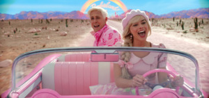 Picture of a blonde woman driving a pink car and singing with a man in the backseat singing along. 