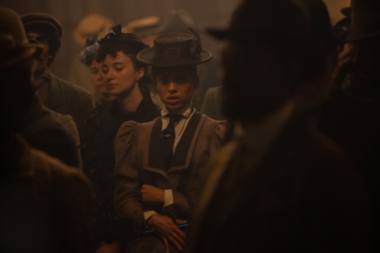 Ravonna Renslayer in a crowd- undercover and in disguise in a 1890s style outfit.