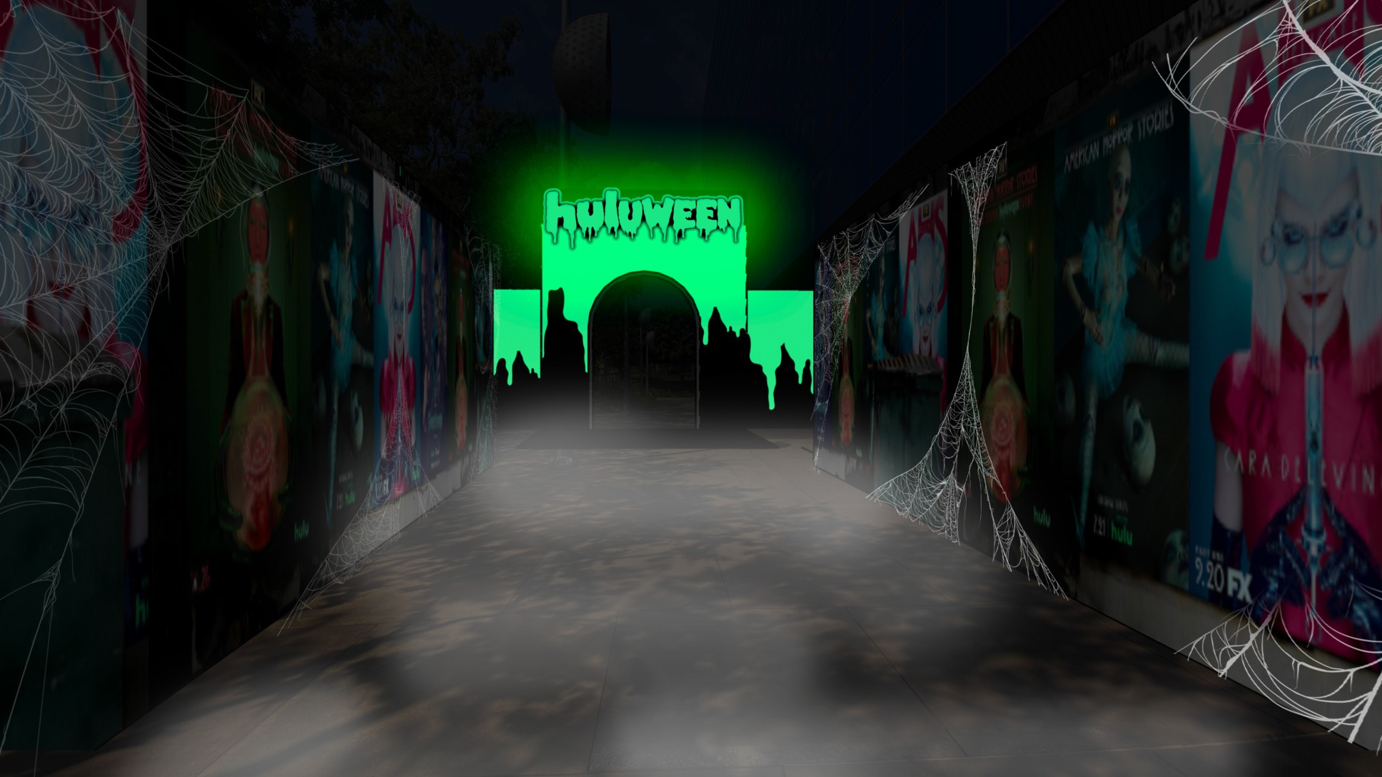 Horror movie posters line a path to a Huluween display in bright green in dripping, Halloween-style text.