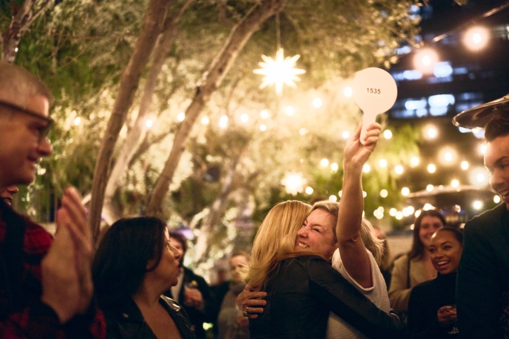 Patricia Clarkson hugs an auction winner