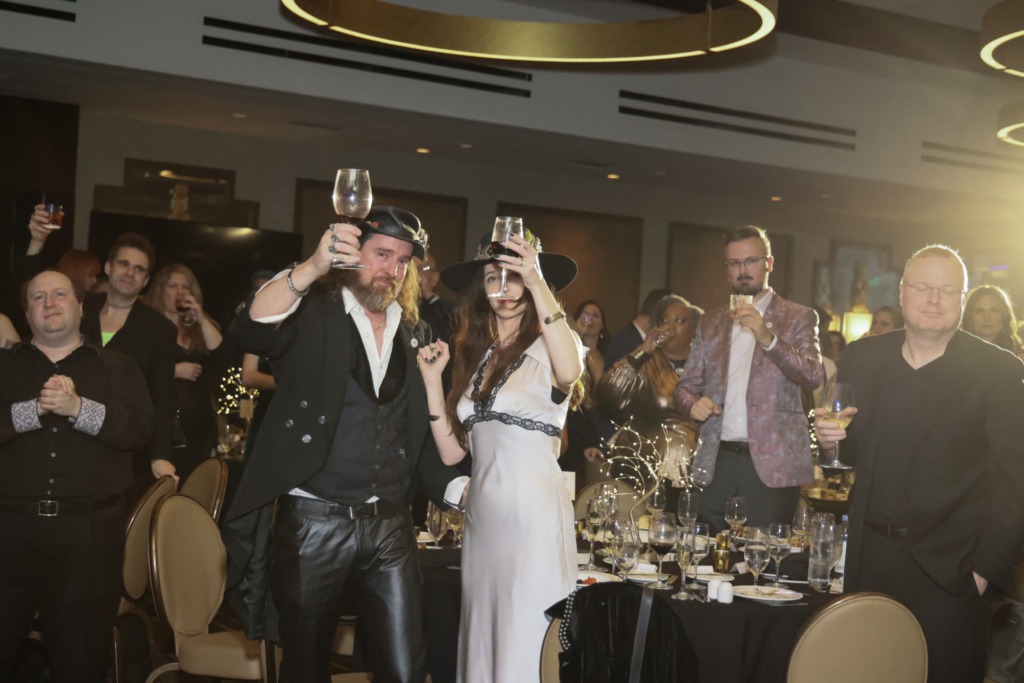 picture of people toasting in a ballroom 