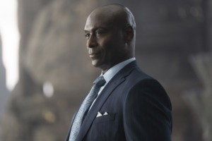 Lance Reddick in a suit in a still from Percy Jackson