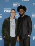 Two men posing on red carpet