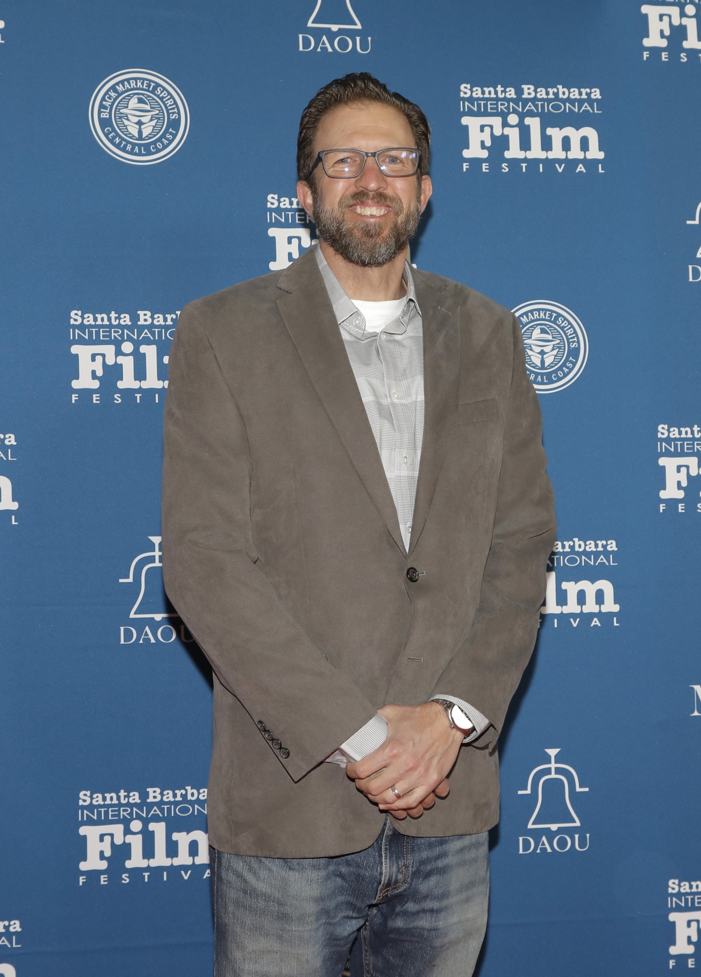 man poses on red carpet