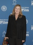 a woman poses on red carpet