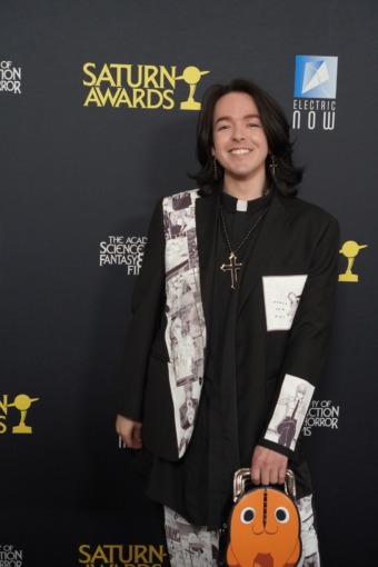 Woman in dress poses on red carpet