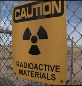 picture of a caution radioactive materials sign on a fence. 