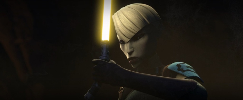 Ventress, pale-skinned with short white hair, hods a yellow lightsaber in front of her scowling face.