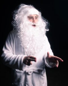 Picture of a man in a white beard and bathrobe 