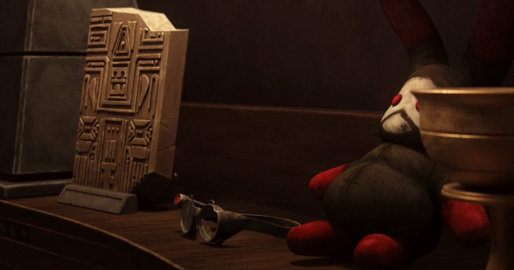 Tech's damaged goggles and Wrecker/Omega's Lula doll sit among other Pabu treasures.