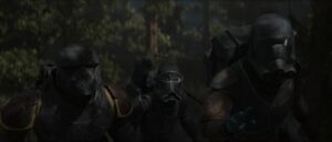 Wrecker, Crosshair, and Hunter, in their black armor, crouch behind tress in the forest around Tantiss.