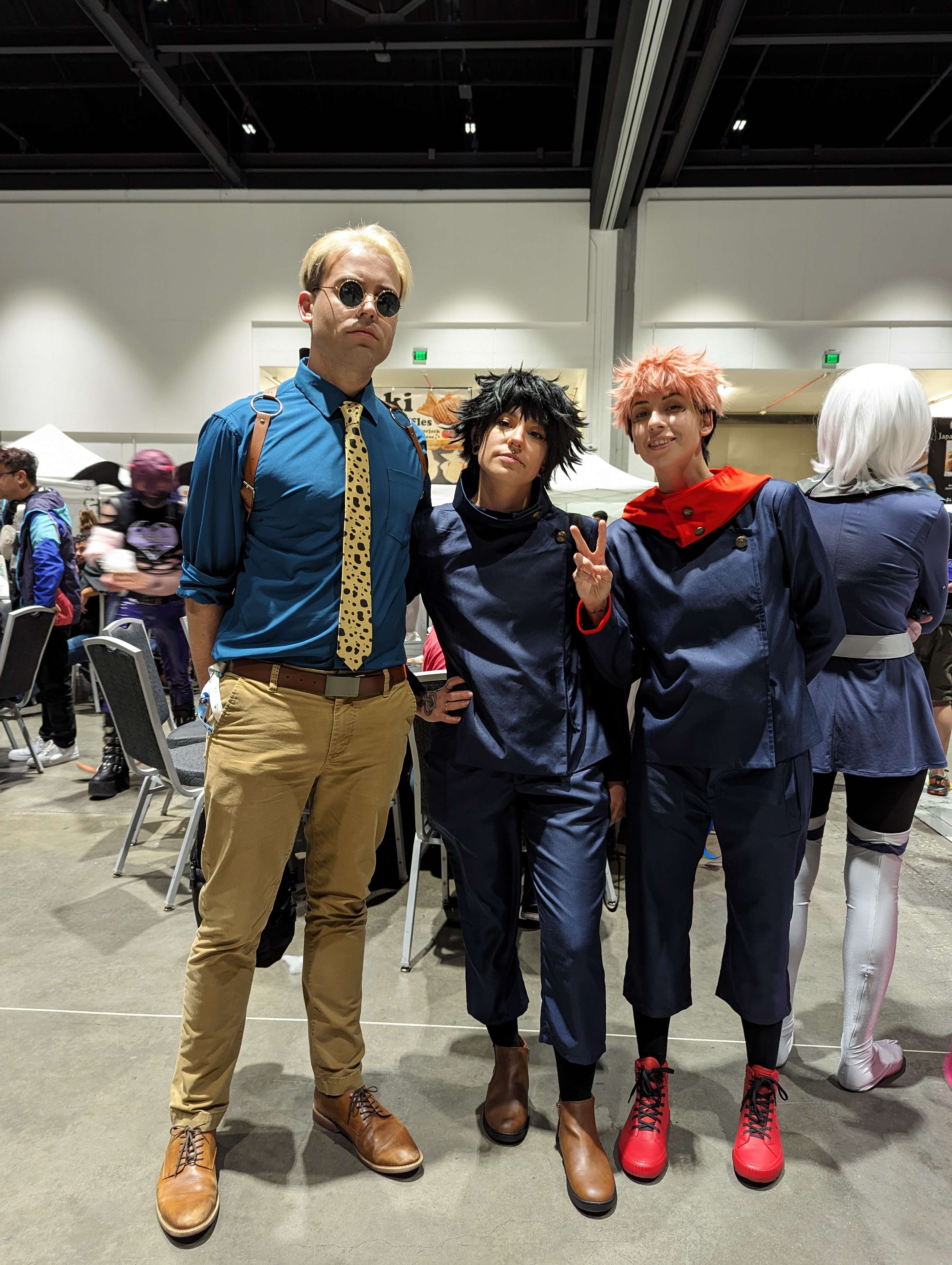 Cosplayers dressing up as Jujutsu Kaisen characters at Fanime inside the convention center