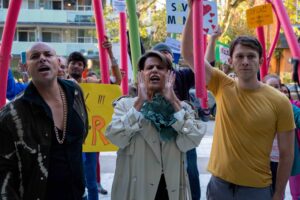 picture of three people at a protest