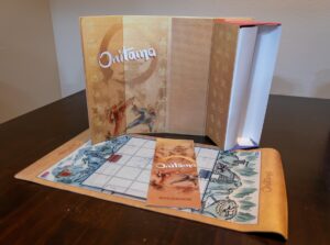 Board Game laid out on table displaying game mat and booklet.