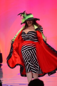 A participant in the Her Universe Fashion Show shows off a Beetlejuice-inspired design.