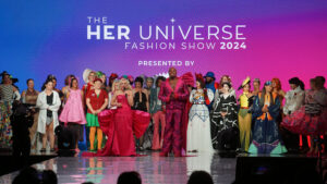 Hosts Ashley Eckstein and Michael James Scott with participants at the Her Universe Fashion Show 2024.