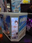 iBUYPOWER booth at Anime Expo displaying prebuilt gaming pcs, feat NIKKE