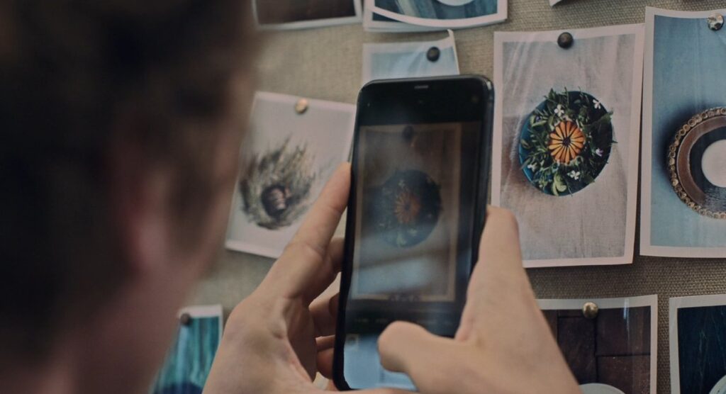 Carmy takes a photo of a photo of a dish he created at Noma.