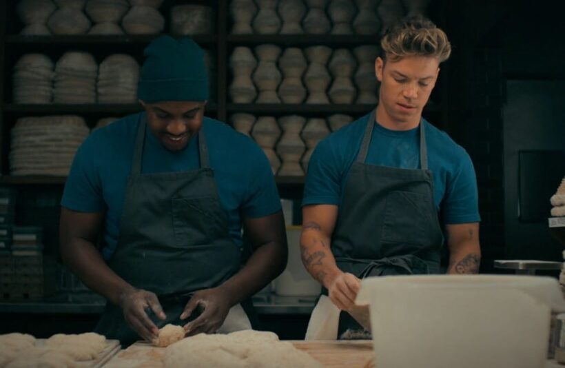 Marcus shapes dough as Luca passes it to him