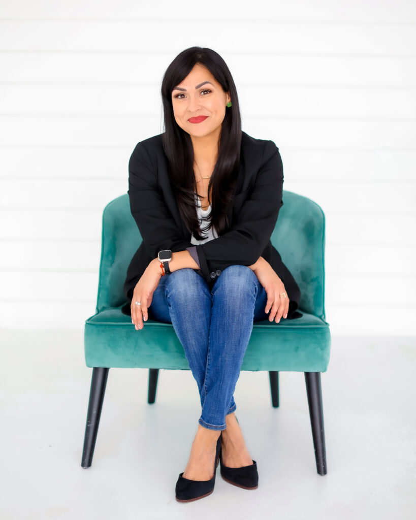 Lileana Roque sits on a teal chair - post con depression discussion